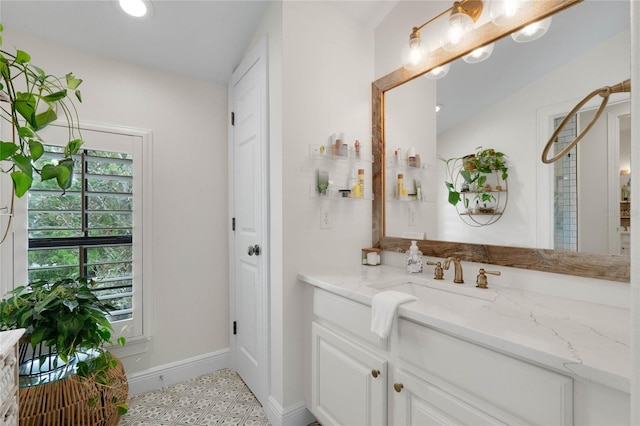 bathroom featuring recessed lighting, baseboards, and vanity