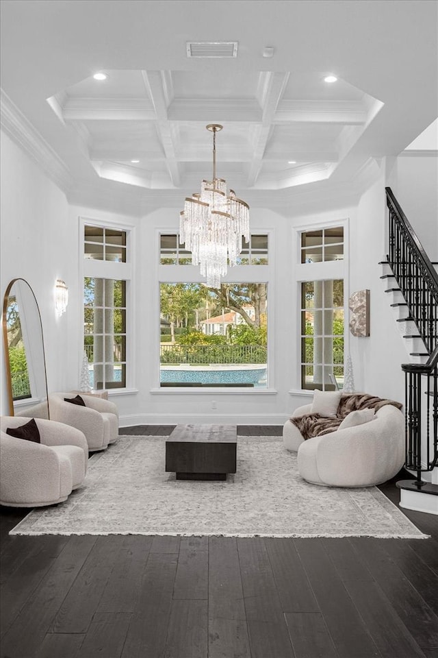 living room with a notable chandelier, stairway, plenty of natural light, and wood finished floors