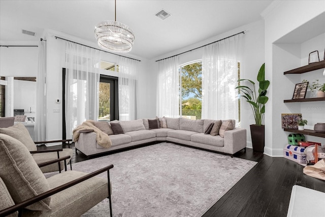 living room featuring visible vents, plenty of natural light, and dark wood-style flooring