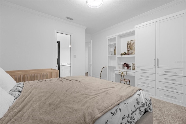 carpeted bedroom with a textured ceiling, crown molding, visible vents, and connected bathroom