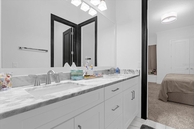 full bathroom with double vanity, a skylight, ensuite bath, and a sink