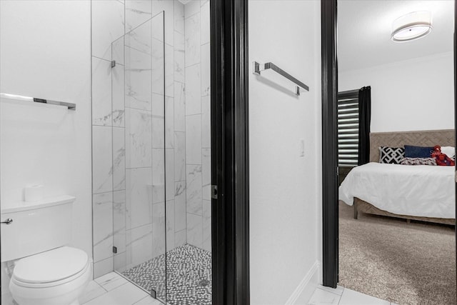 ensuite bathroom featuring a marble finish shower, toilet, marble finish floor, and ensuite bathroom