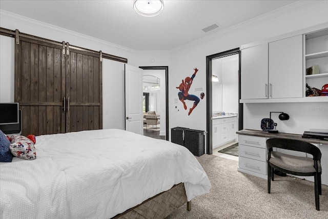 bedroom with visible vents, light carpet, a textured ceiling, ensuite bath, and crown molding