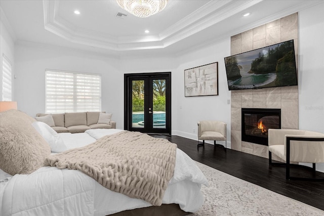 bedroom featuring dark wood finished floors, crown molding, access to outside, and visible vents