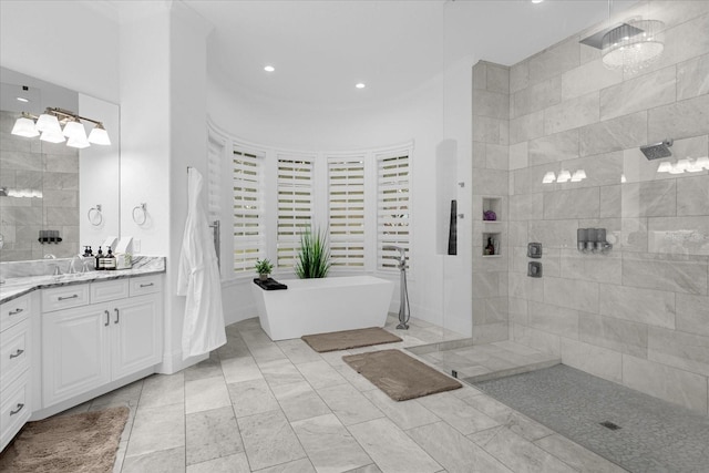 bathroom featuring vanity, a soaking tub, and walk in shower