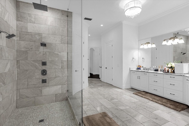 bathroom with vanity, baseboards, visible vents, walk in shower, and crown molding