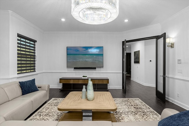 living room featuring crown molding, baseboards, recessed lighting, wood finished floors, and a notable chandelier