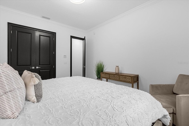 bedroom with crown molding and visible vents