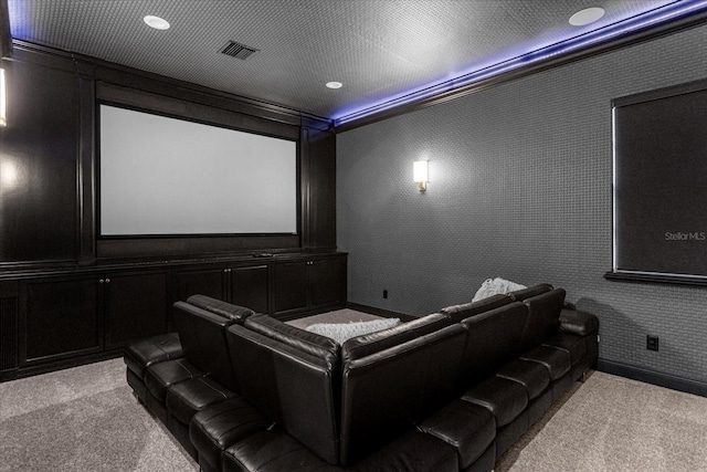 carpeted cinema featuring wallpapered walls, a decorative wall, and visible vents