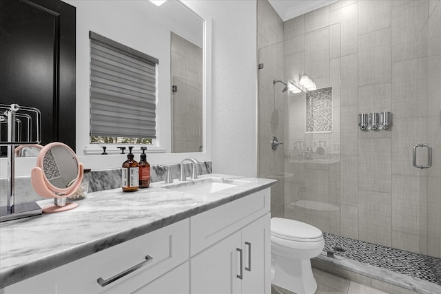 full bath with vanity, toilet, and a stall shower