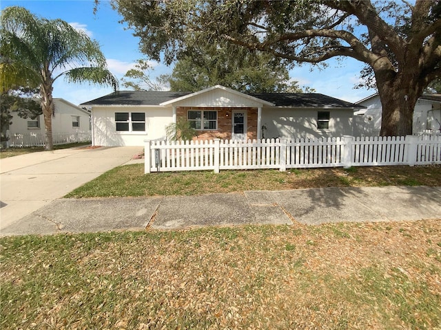 ranch-style home featuring a fenced front yard