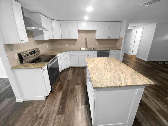 kitchen featuring dark wood-style floors, a sink, stainless steel range with electric cooktop, dishwasher, and wall chimney range hood