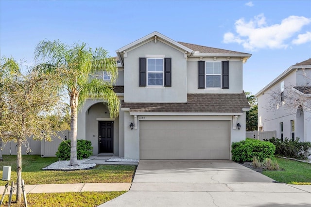 3179 Turret Dr, Kissimmee, FL 34743 - traditional-style house featuring a shingled roof, fence, concrete driveway, stucco siding, and a garage