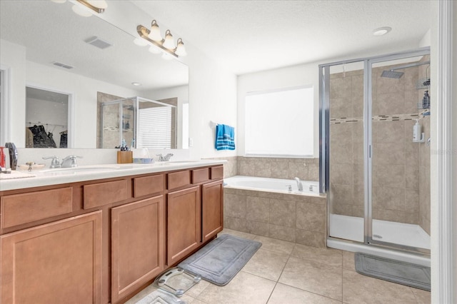 full bathroom featuring tile patterned floors, visible vents, a stall shower, a sink, and a bath