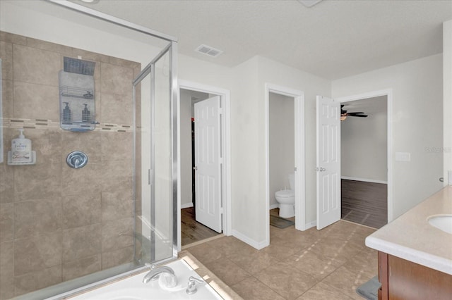 bathroom featuring baseboards, visible vents, toilet, a shower stall, and a bath