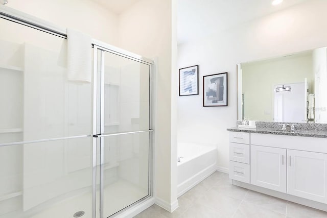 bathroom with tile patterned flooring, a stall shower, vanity, and a garden tub