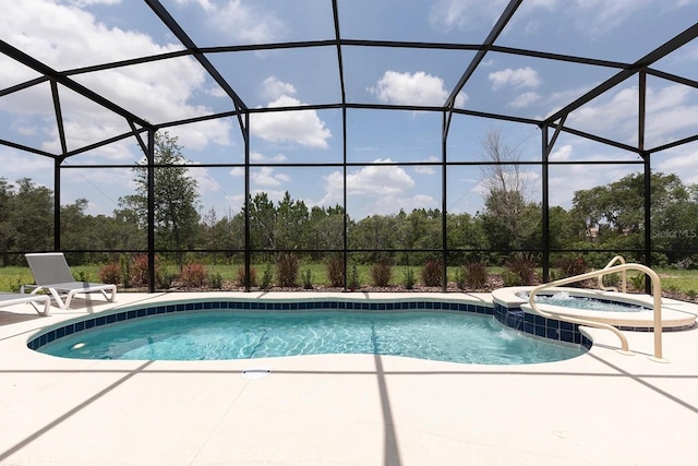 view of pool featuring a lanai, a patio area, and a pool with connected hot tub