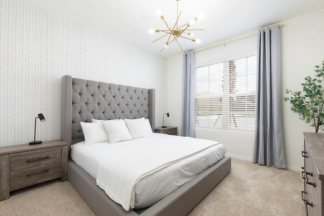 bedroom featuring baseboards, light colored carpet, wallpapered walls, and an inviting chandelier