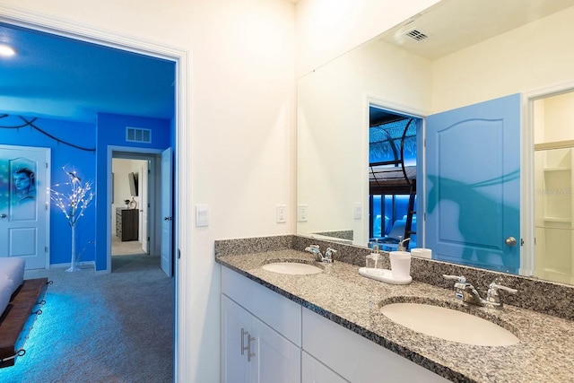 full bathroom with double vanity, visible vents, and a sink