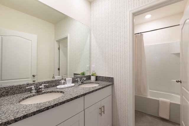 bathroom with tile patterned flooring, double vanity, shower / bathtub combination with curtain, and a sink