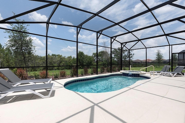 view of swimming pool featuring a pool with connected hot tub, a lanai, and a patio area