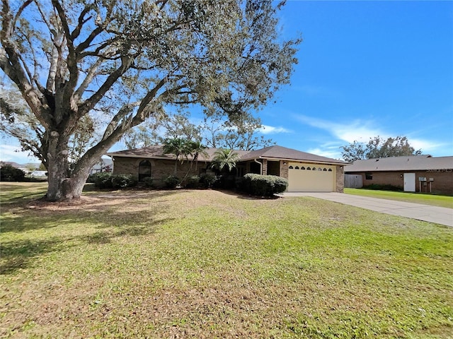 single story home featuring concrete driveway, an attached garage, brick siding, and a front yard