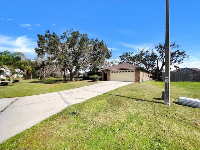 view of front facade featuring concrete driveway, an attached garage, brick siding, and a front yard