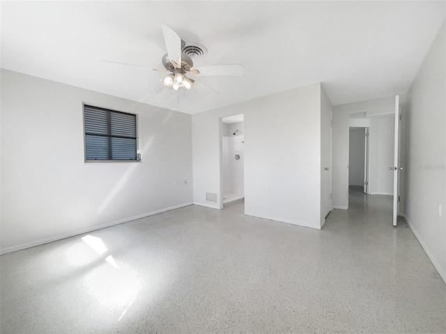 unfurnished room featuring baseboards, light speckled floor, and a ceiling fan