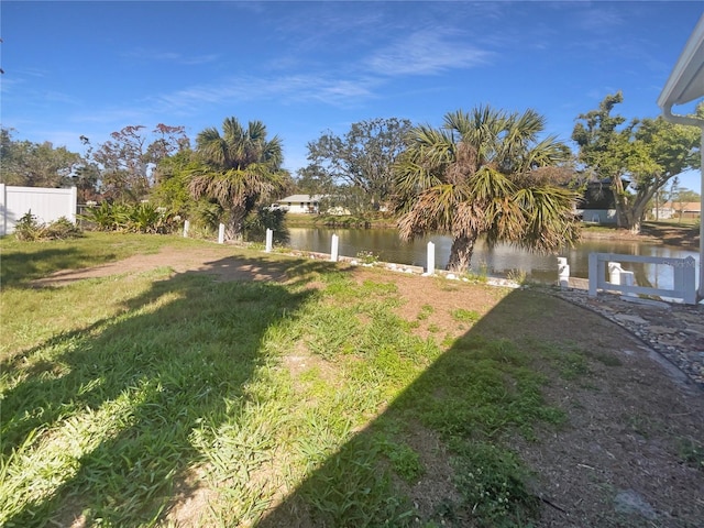 view of yard with fence and a water view