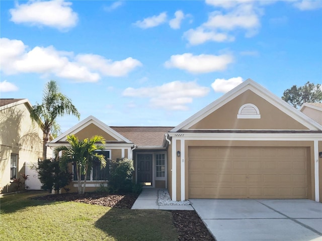 single story home featuring stucco siding, concrete driveway, a garage, and a front yard