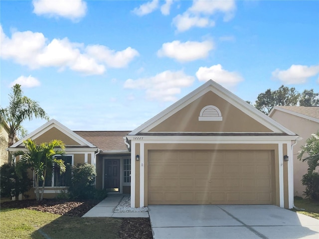 single story home featuring a garage, driveway, and stucco siding