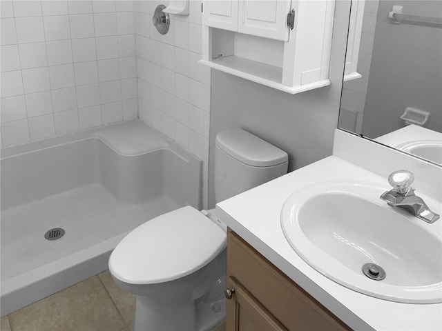 full bath with a shower, toilet, vanity, and tile patterned flooring