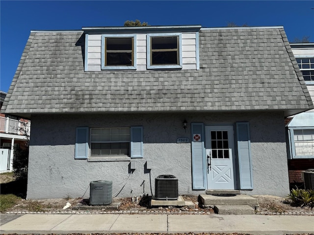 7309 Daniel Webster Dr Unit D, Winter Park, FL 32792 - view of front of property with central AC unit, stucco siding, mansard roof, and a shingled roof