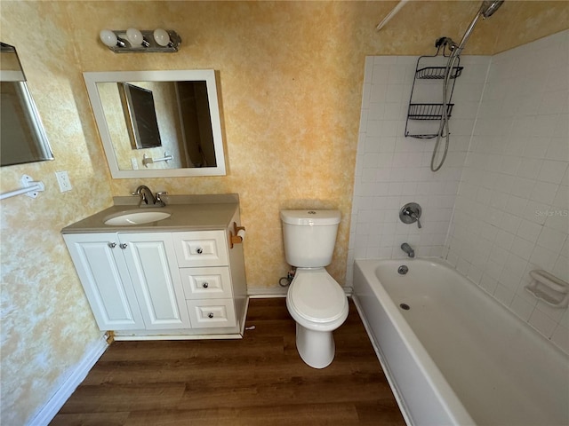 full bath with toilet, shower / tub combination, baseboards, and wood finished floors