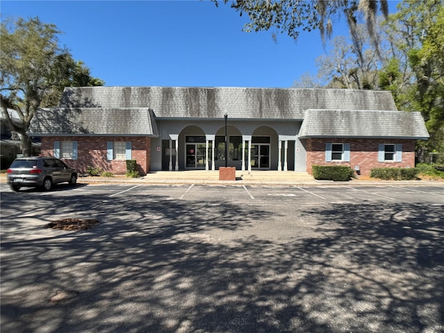 view of building exterior with uncovered parking