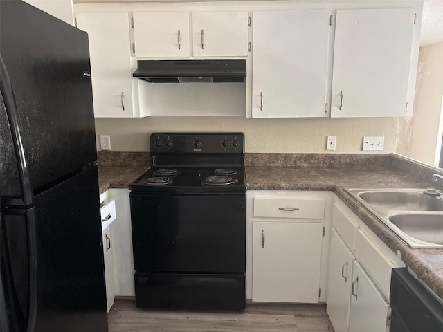 kitchen featuring white cabinetry, black appliances, under cabinet range hood, and a sink