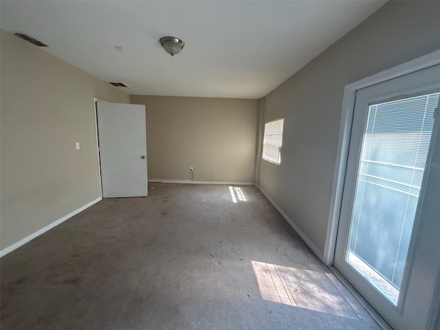 empty room featuring visible vents and baseboards