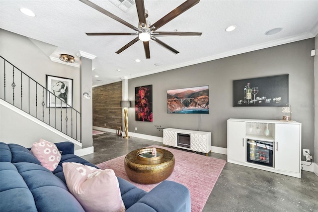 living room featuring stairway, a textured ceiling, and concrete floors