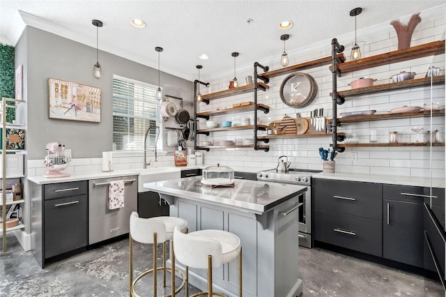 kitchen with open shelves, a sink, a kitchen breakfast bar, appliances with stainless steel finishes, and dark cabinets