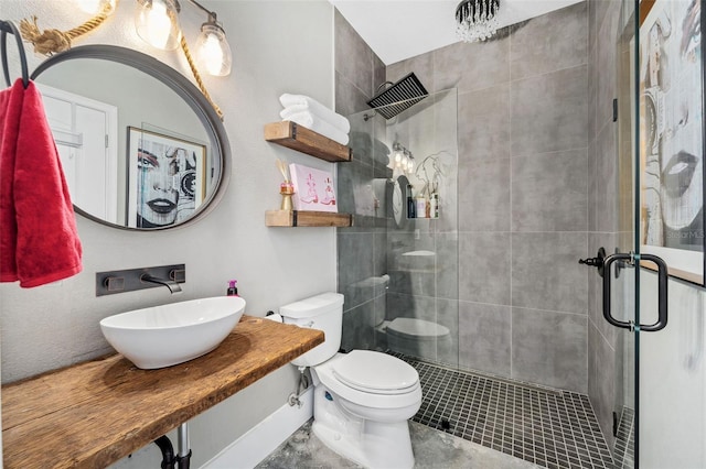 full bath featuring a sink, toilet, and a shower stall