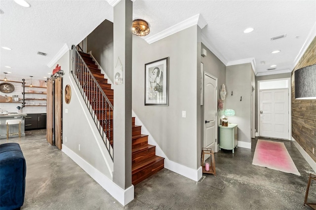 entrance foyer with visible vents, a textured ceiling, recessed lighting, baseboards, and stairs