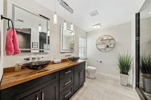 full bath featuring tile patterned flooring, toilet, visible vents, and a sink