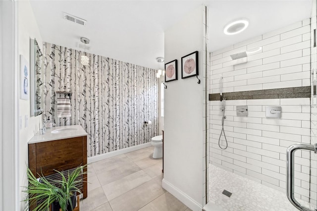 full bath with visible vents, baseboards, toilet, a stall shower, and vanity