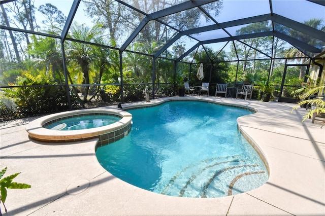 view of pool with glass enclosure, a patio, and a pool with connected hot tub