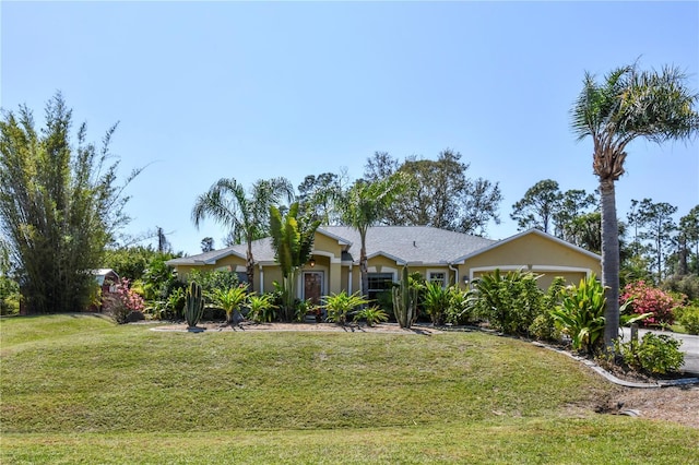 view of front facade with a front lawn, a garage, and stucco siding