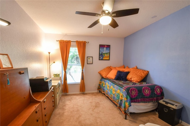 bedroom with baseboards, light carpet, and ceiling fan