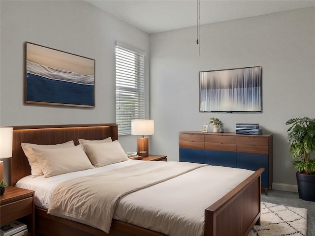 bedroom with baseboards and carpet