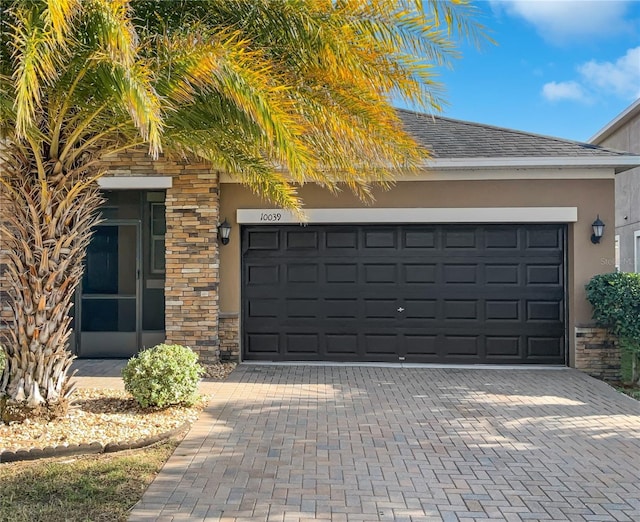 garage with decorative driveway