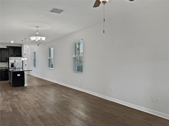 kitchen with visible vents, baseboards, open floor plan, stainless steel refrigerator with ice dispenser, and dark wood-style flooring