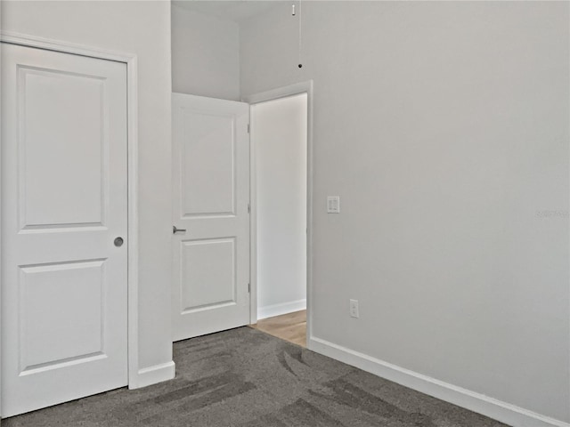 unfurnished bedroom featuring carpet flooring and baseboards